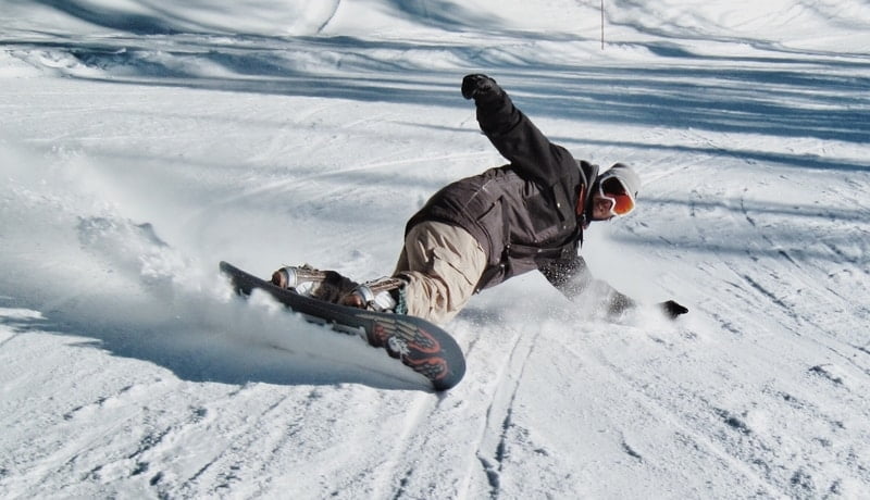 Skidding snowboarder in snow