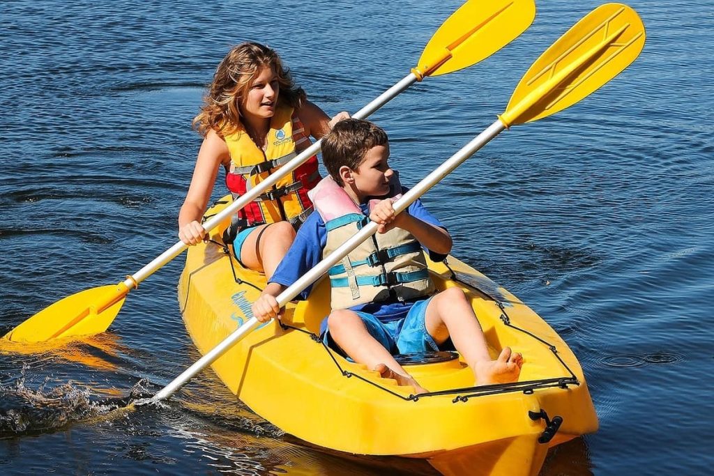 Kids in a sit on top kayak