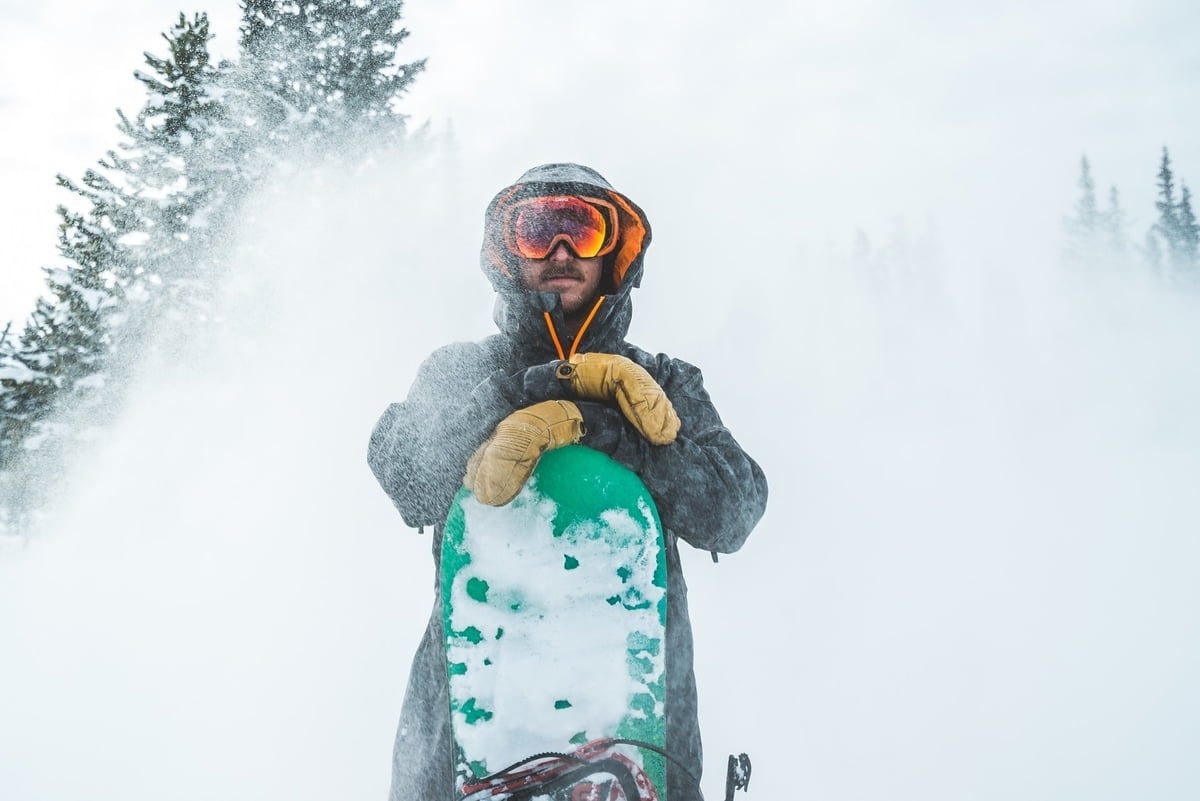 person standing with snowboard