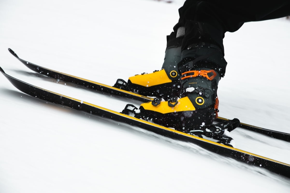 Yellow ski boots on skis