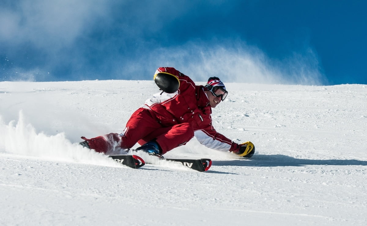 man skiing down slope